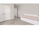 Neutral bedroom with gray carpet, a daybed with storage drawers, and white doors leading to additional rooms at 12199 Xavier Ave, Port Charlotte, FL 33981