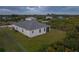 Rear-angled aerial shot displays the home's back exterior and backyard at 12199 Xavier Ave, Port Charlotte, FL 33981