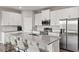 Modern kitchen with granite countertops, stainless steel appliances, and a center island with seating at 12199 Xavier Ave, Port Charlotte, FL 33981