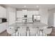 Stylish kitchen featuring white cabinets, granite counters, stainless appliances, and bar seating at 12199 Xavier Ave, Port Charlotte, FL 33981