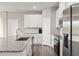 Functional kitchen featuring granite countertops, stainless steel appliances, and modern white cabinetry at 12199 Xavier Ave, Port Charlotte, FL 33981