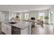 Light-filled living space merges a kitchen, dining area, and living room with a contemporary design at 12199 Xavier Ave, Port Charlotte, FL 33981