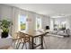 Open-concept living area with ample natural light, hardwood floors, and stylish modern furniture at 12199 Xavier Ave, Port Charlotte, FL 33981
