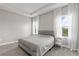 Comfortable main bedroom with plush carpet, tray ceiling, neutral walls, and natural light at 12199 Xavier Ave, Port Charlotte, FL 33981