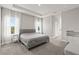 Serene bedroom featuring plush carpeting, tray ceiling, and plenty of natural light from multiple windows at 12199 Xavier Ave, Port Charlotte, FL 33981