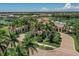 Stunning aerial view of the community showcasing lush landscaping, a pool, and lake views at 12515 Felice Dr, Venice, FL 34293