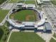 Aerial view of the baseball stadium with green field, and parking. and the surrounding community at 12515 Felice Dr, Venice, FL 34293
