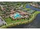 An aerial view of the community shows the pool, clubhouse, tennis courts and surrounding lakes at 12515 Felice Dr, Venice, FL 34293