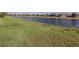 Backyard featuring lush grass and a tranquil canal view; a serene outdoor retreat at 12515 Felice Dr, Venice, FL 34293
