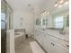 A Primary bathroom with double sinks, soaking tub, walk-in shower, and modern fixtures at 12515 Felice Dr, Venice, FL 34293