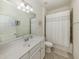 Neat and tidy bathroom with a tub and shower combination, white vanity, and neutral-colored walls at 12515 Felice Dr, Venice, FL 34293