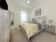 Cozy bedroom with a full bed, light wood dresser, a mirror, and neutral decor at 12515 Felice Dr, Venice, FL 34293