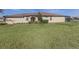 Well-maintained home featuring a manicured lawn, lush landscaping, and a screened-in patio at 12515 Felice Dr, Venice, FL 34293