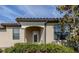 Charming home featuring an inviting front door and decorative accents with well manicured landscaping at 12515 Felice Dr, Venice, FL 34293