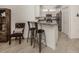 Stylish breakfast bar with seating, set in an open kitchen with white cabinetry and granite countertops at 12515 Felice Dr, Venice, FL 34293