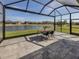 Screened lanai offering a tranquil view of the pond, creating an ideal outdoor living space at 12515 Felice Dr, Venice, FL 34293
