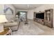 The well-lit living room features comfortable seating, stylish décor, and sliding door access to outdoor space at 12515 Felice Dr, Venice, FL 34293