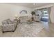 Inviting living room with comfortable seating, modern decor, and sliding glass doors to the lanai at 12515 Felice Dr, Venice, FL 34293