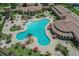 Aerial view featuring a resort-style pool, ample seating, lush landscaping, and community amenities at 12515 Felice Dr, Venice, FL 34293