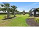 Lush backyard features mature palm trees and well-maintained landscaping, perfect for outdoor enjoyment at 12897 Oriago St, Venice, FL 34293