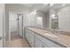 Bathroom featuring double granite vanity, large mirror, and walk-in closet at 12897 Oriago St, Venice, FL 34293