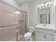 Clean and bright bathroom with a shower featuring a sliding glass door at 12897 Oriago St, Venice, FL 34293