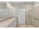 Bathroom featuring a single granite vanity and glass enclosed shower with seating at 12897 Oriago St, Venice, FL 34293