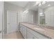 Bright bathroom featuring double granite vanity, large mirror, and walk-in shower at 12897 Oriago St, Venice, FL 34293