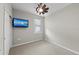 Cozy bedroom with neutral walls, ceiling fan, and a mounted television at 12897 Oriago St, Venice, FL 34293