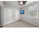 Well lit bedroom features neutral walls, ceiling fan, a mounted TV and closet with sliding doors at 12897 Oriago St, Venice, FL 34293