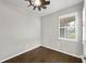 Bedroom with hard wood flooring, white shuttered window, and neutral walls at 12897 Oriago St, Venice, FL 34293