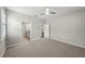 Bedroom with carpeted floors, ceiling fan, view of bathroom and hall doors at 12897 Oriago St, Venice, FL 34293