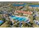 Beautiful aerial view of a community pool surrounded by lush landscaping, palm trees, and inviting lounge areas at 12897 Oriago St, Venice, FL 34293