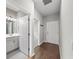 Hallway with hardwood floors, a gray color scheme and access to the bathroom, a bedroom and the front door at 12897 Oriago St, Venice, FL 34293