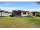 Well-maintained backyard featuring a screened lanai and mature landscaping, providing a private outdoor space at 12897 Oriago St, Venice, FL 34293