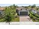 Charming single-story home showcasing a tile roof, two-car garage, brick paver driveway, and well-maintained landscaping at 12897 Oriago St, Venice, FL 34293