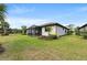 Charming home exterior with lush lawn, screened lanai, and well-maintained landscaping at 12897 Oriago St, Venice, FL 34293