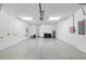 Spacious three-car garage features epoxy floors, utility sink, and ample room for storage and projects at 12897 Oriago St, Venice, FL 34293
