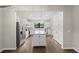 Modern kitchen with stainless steel appliances, white cabinets, granite countertops, and large island at 12897 Oriago St, Venice, FL 34293