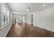 Bright living room with hardwood floors, open floor plan, large windows and modern ceiling fan at 12897 Oriago St, Venice, FL 34293
