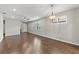 Spacious living room with hardwood floors, bright light, and an open floor plan with neutral walls at 12897 Oriago St, Venice, FL 34293