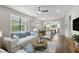 Open-concept living room showcasing plantation shutters, hardwood floors, and seamless access to the dining and kitchen areas at 12897 Oriago St, Venice, FL 34293