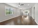 Bright living room with hardwood floors, open floor plan, large windows and modern ceiling fan at 12897 Oriago St, Venice, FL 34293