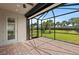Screened patio with brick flooring offers an inviting space with backyard views and natural light at 12897 Oriago St, Venice, FL 34293