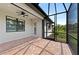 Screened lanai featuring brick flooring and an outdoor ceiling fan, ideal for relaxing and entertaining at 12897 Oriago St, Venice, FL 34293