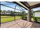Covered patio with brick flooring offers serene views of the lush backyard and mature landscaping at 12897 Oriago St, Venice, FL 34293