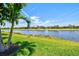 Backyard view overlooking a tranquil lake and the neighboring residences at 13202 Borrego St, Venice, FL 34293