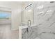 Bright bathroom showcasing a glass enclosed shower with beautiful marble-style tiling and bench at 13202 Borrego St, Venice, FL 34293