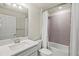 Modern bathroom with decorative tile and shower, vanity with white countertop and chrome faucet at 13202 Borrego St, Venice, FL 34293