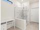 Bright bathroom featuring a glass enclosed shower with beautiful marble tiling at 13202 Borrego St, Venice, FL 34293